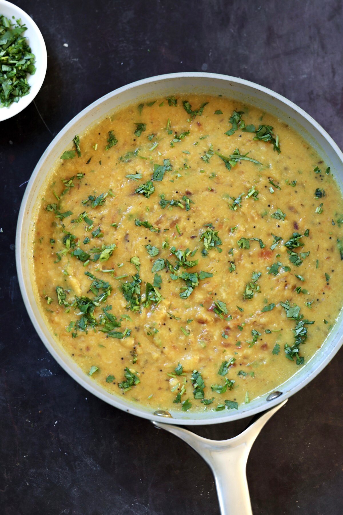 dal fry in the pan topped with fresh cilantro