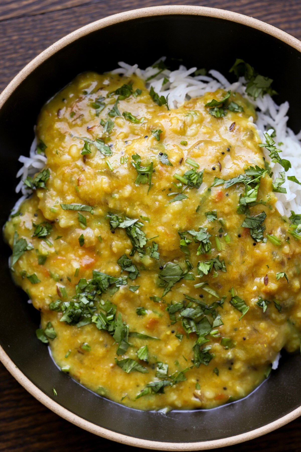 bowl of dal fry with rice and cilantro
