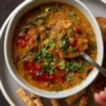 spoon scooping a bite of lentil and spinach soup