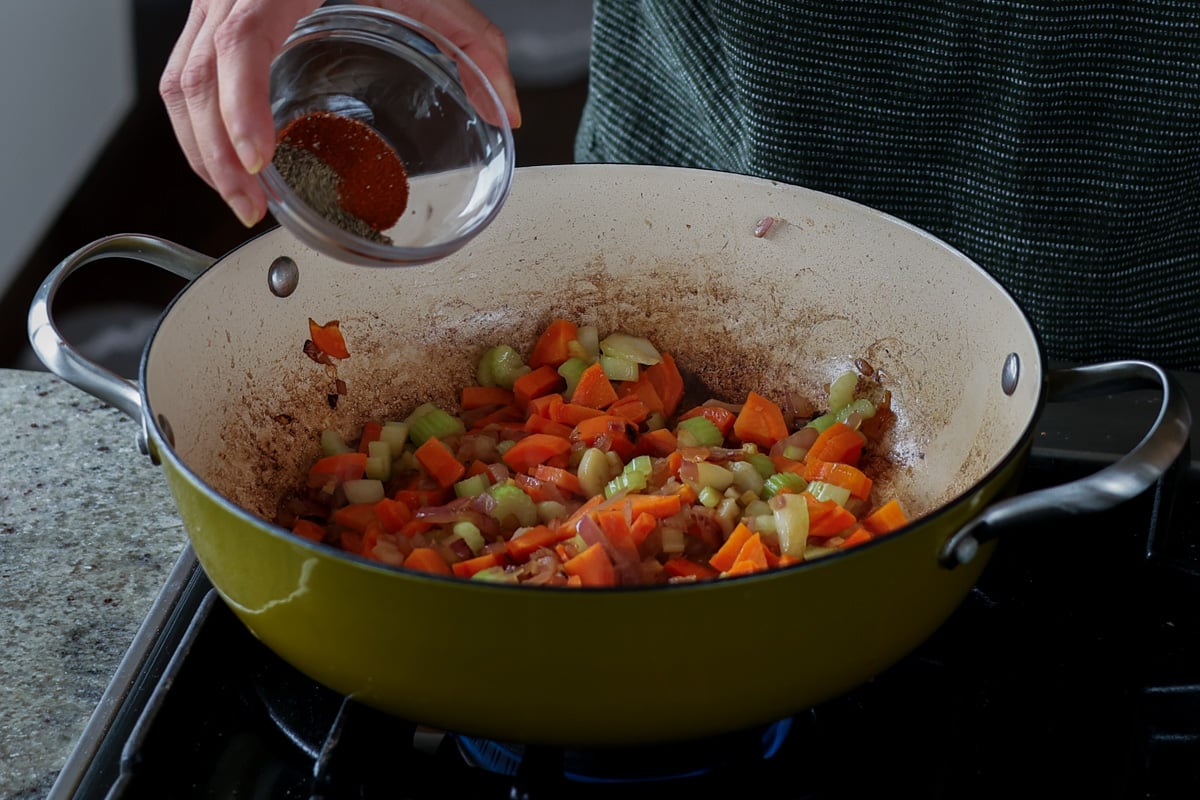 adding spices to the cooked veggies