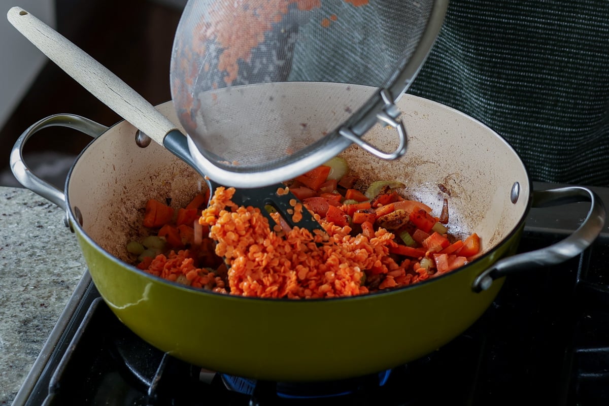 adding rinsed lentils to the pan