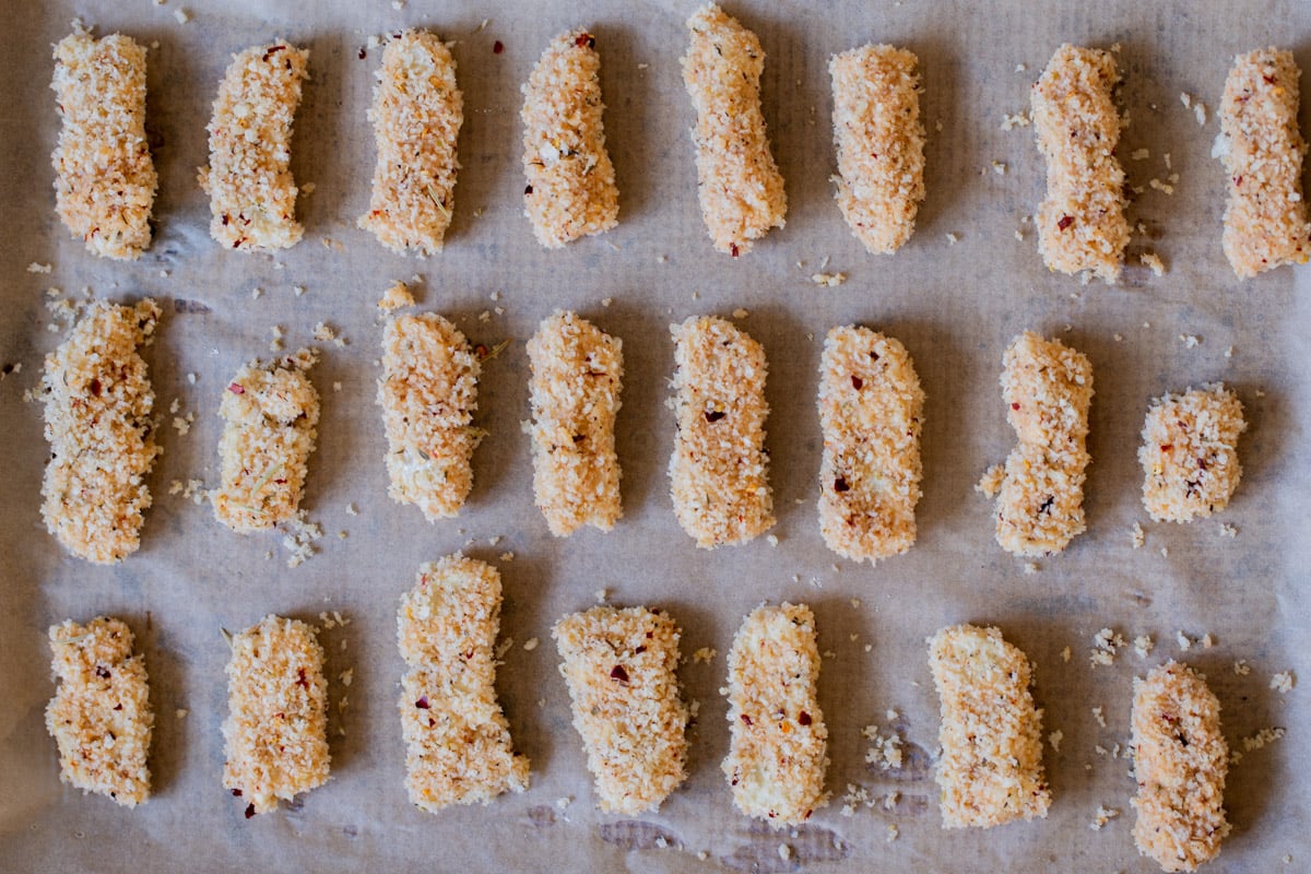 vegan mozzarella sticks on the baking sheet before baking