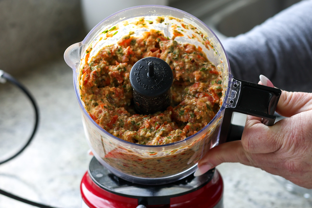 Sicilian pesto sauce ingredients in the food processor after processing