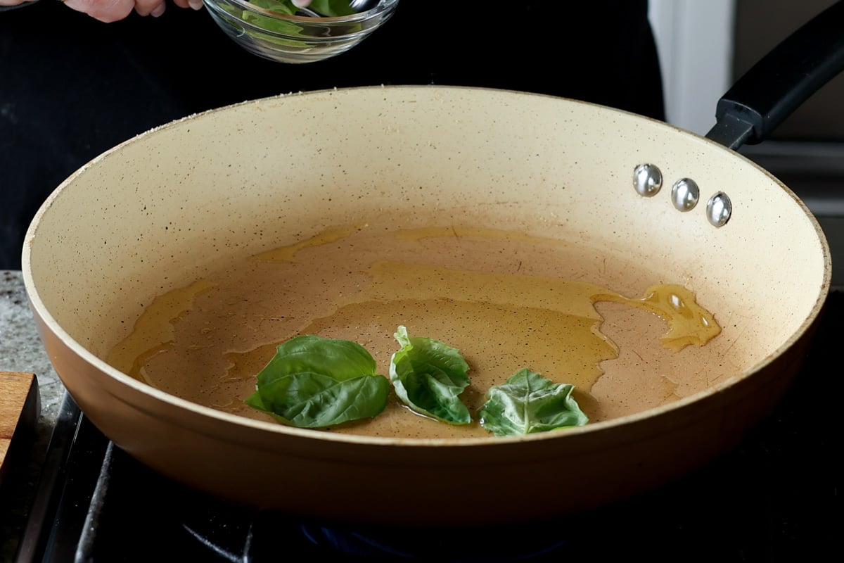 basil in a pan with oil