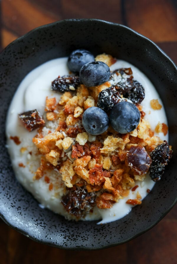 close-up of a bowl of yogurt topped with red lentil granola