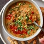 spoon taking a bite of red lentil spinach soup