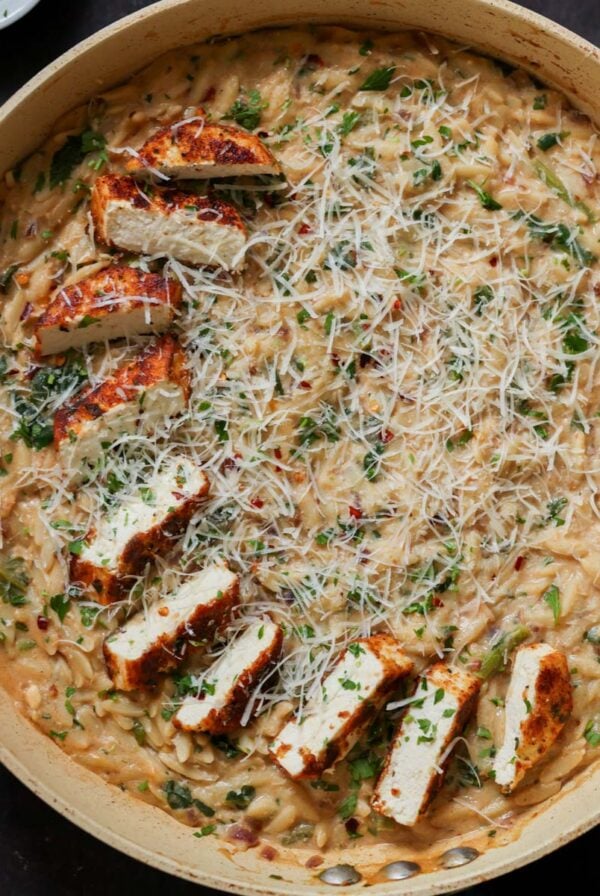 garlic parmesan orzo in the pan with the crispy tofu
