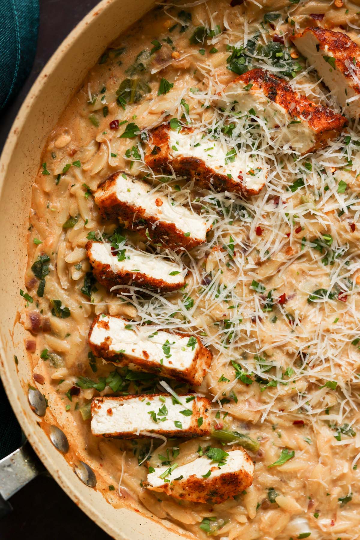 close-up of garlic parmesan orzo in the pan with the crispy tofu