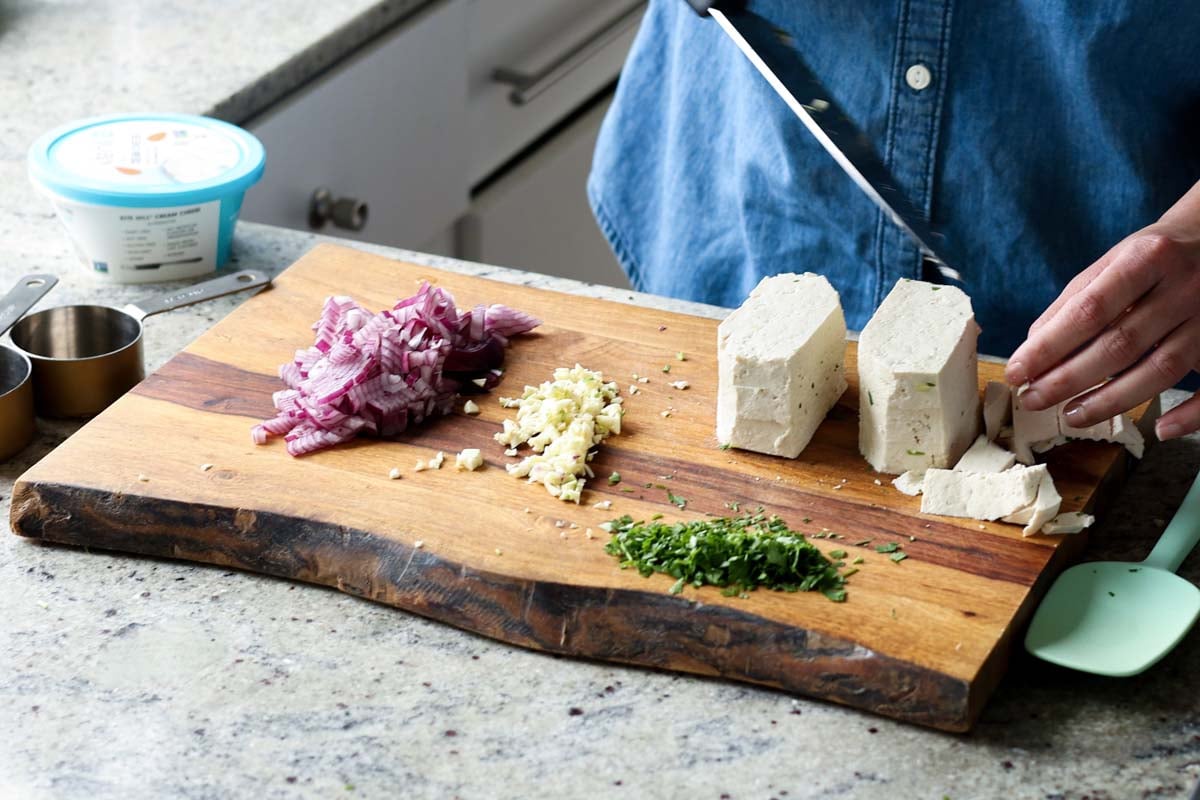tofu and chopped veggies on the cutting board