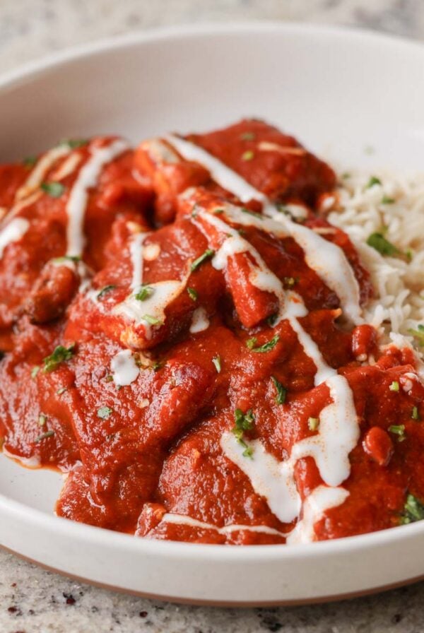 bowl of Kashmiri lal tofu and rice topped with non-dairy yogurt