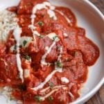 bowl of Kashmiri lal tofu and rice topped with non-dairy yogurt