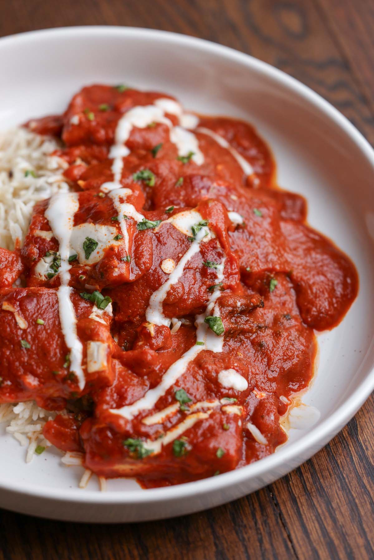 bowl of Kashmiri lal tofu and rice topped with non-dairy yogurt