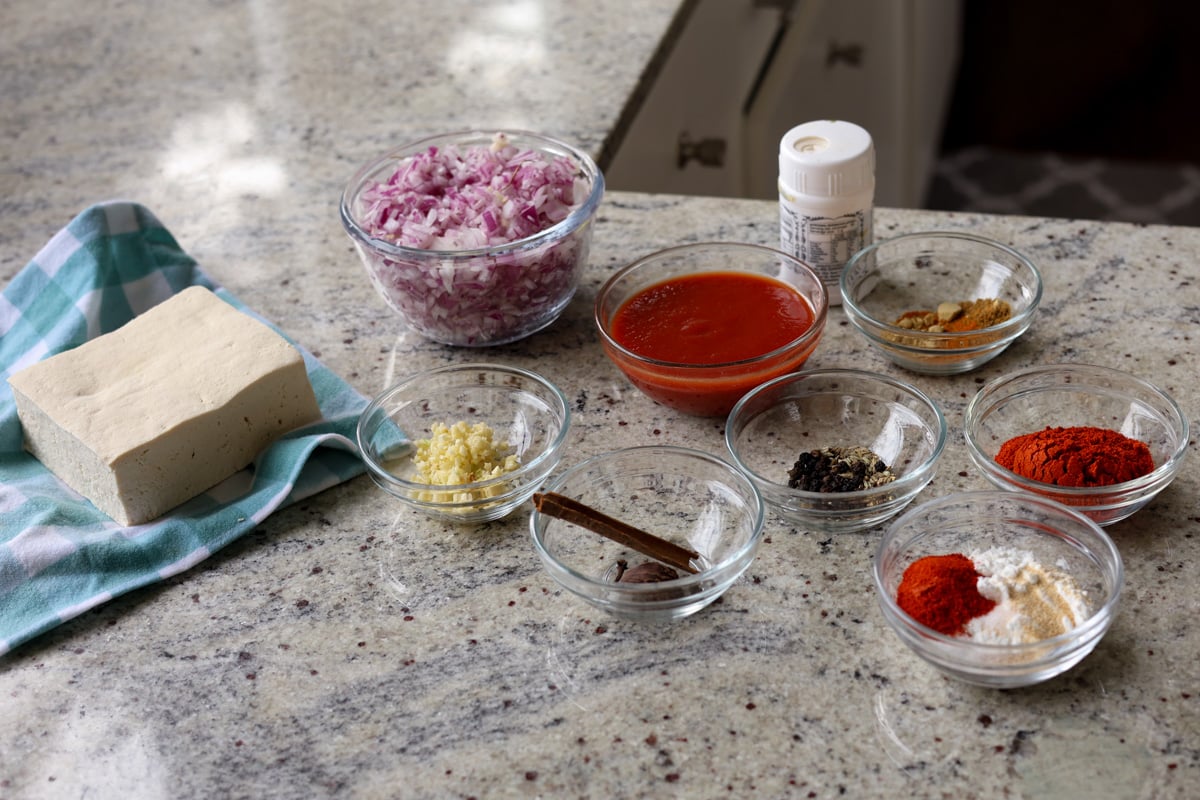 Kashmiri lal paneer ingredients in bowls on the kitchen counter
