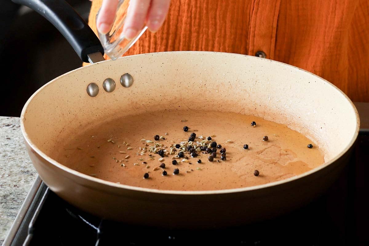 adding whole spices to the pan