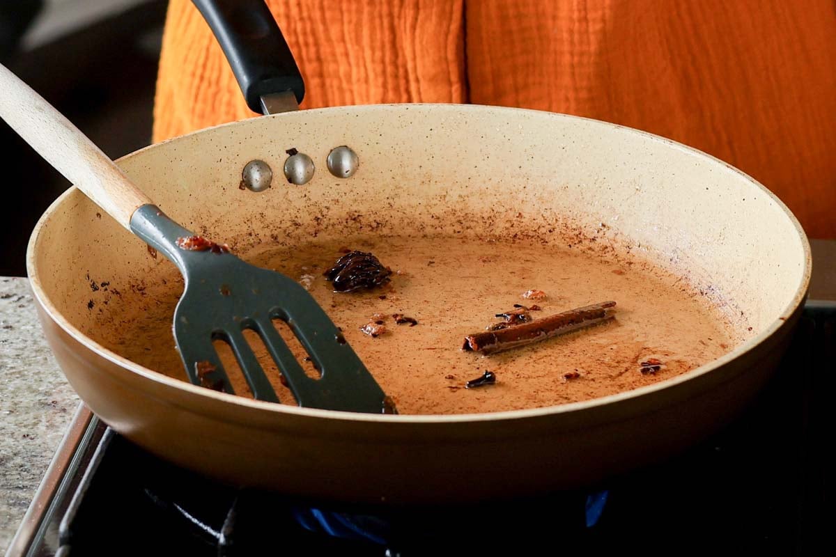 adding more whole spices to the pan