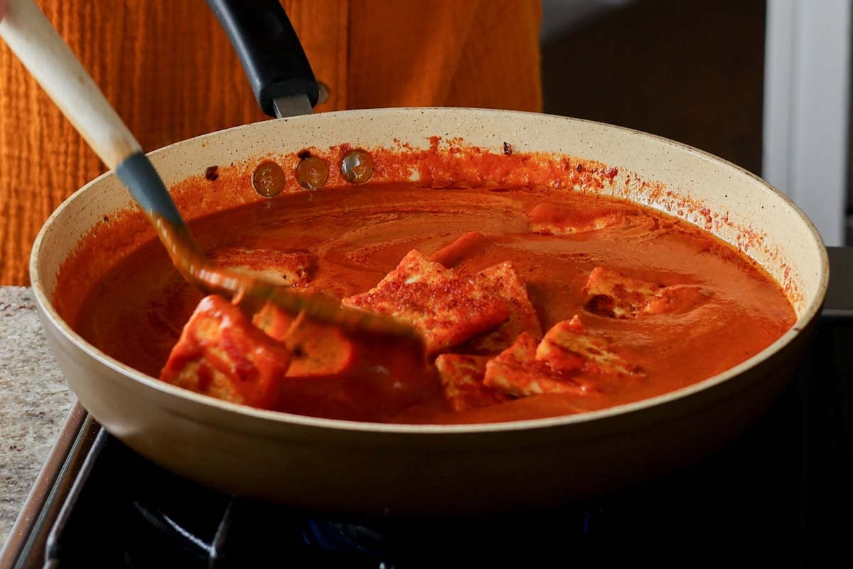 tossing the crispy tofu paneer into the sauce