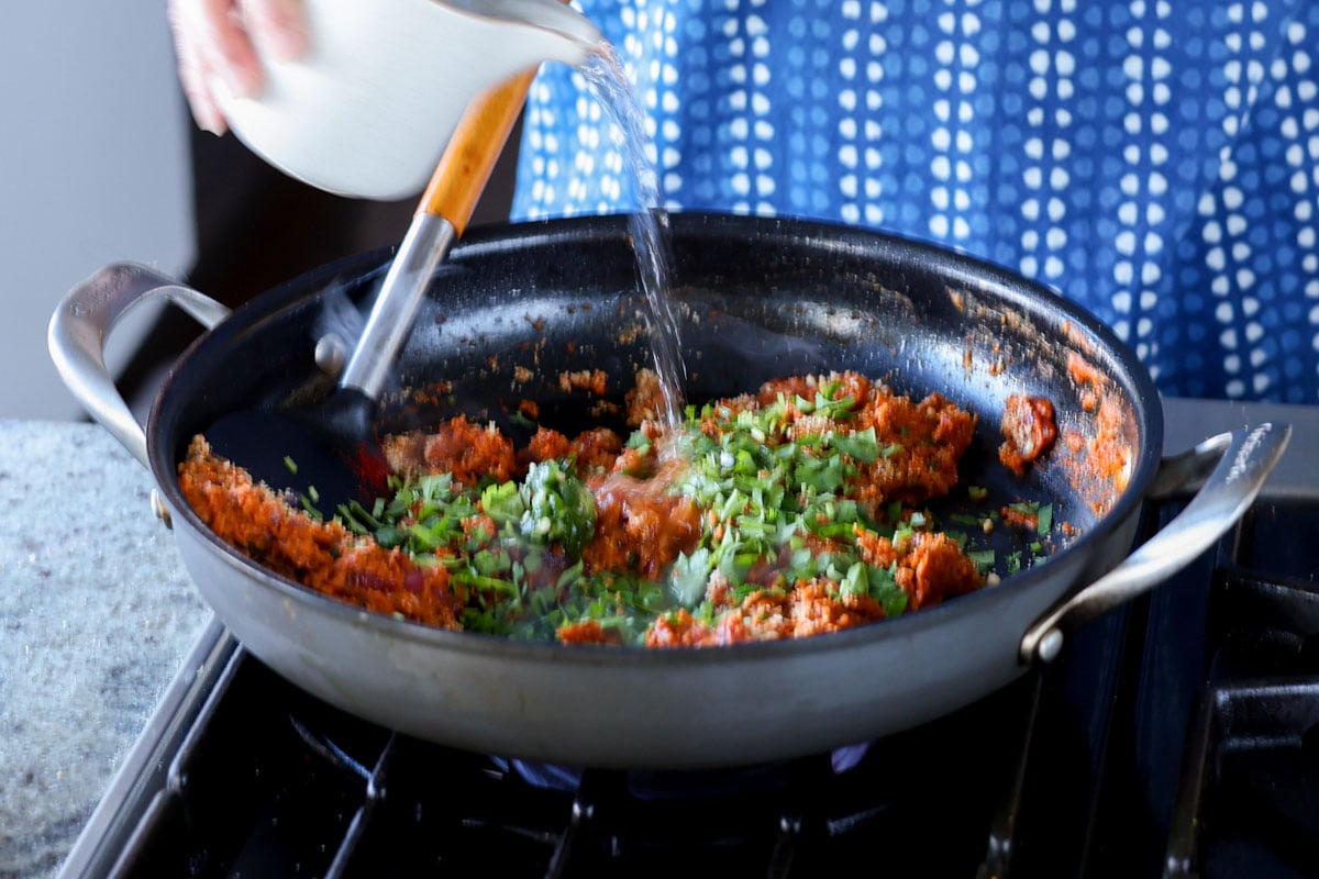 adding herbs to the pan