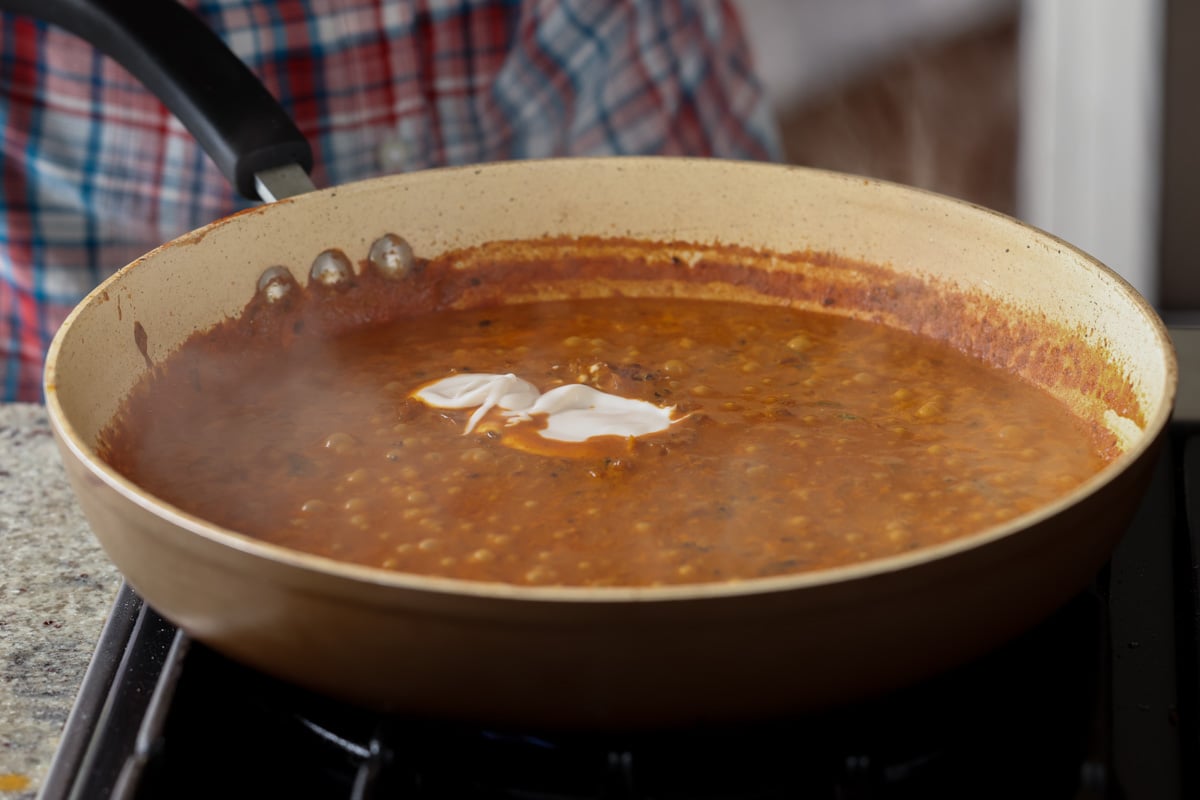 adding more non-dairy yogurt to the sauce