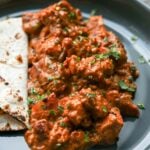 paneer ghee roast on a plate with flatbread