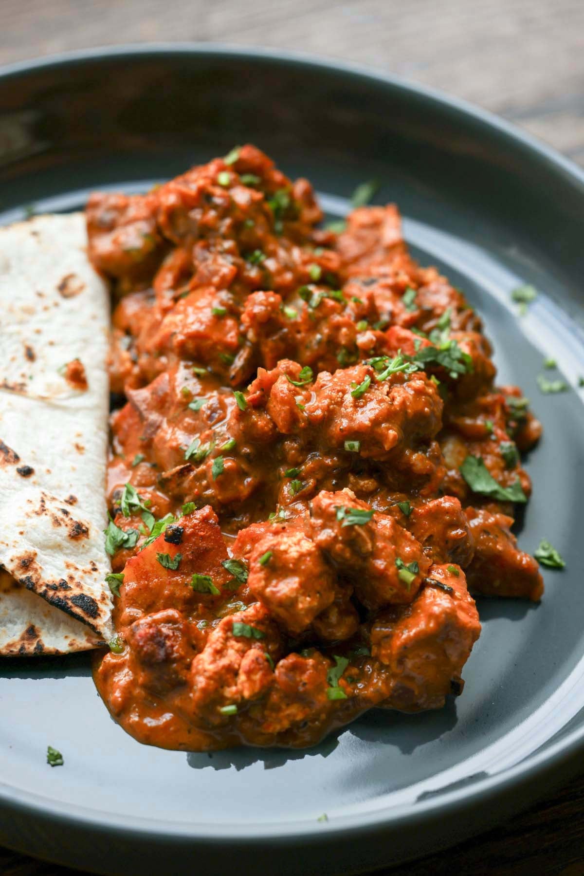 paneer ghee roast on a plate with flatbread