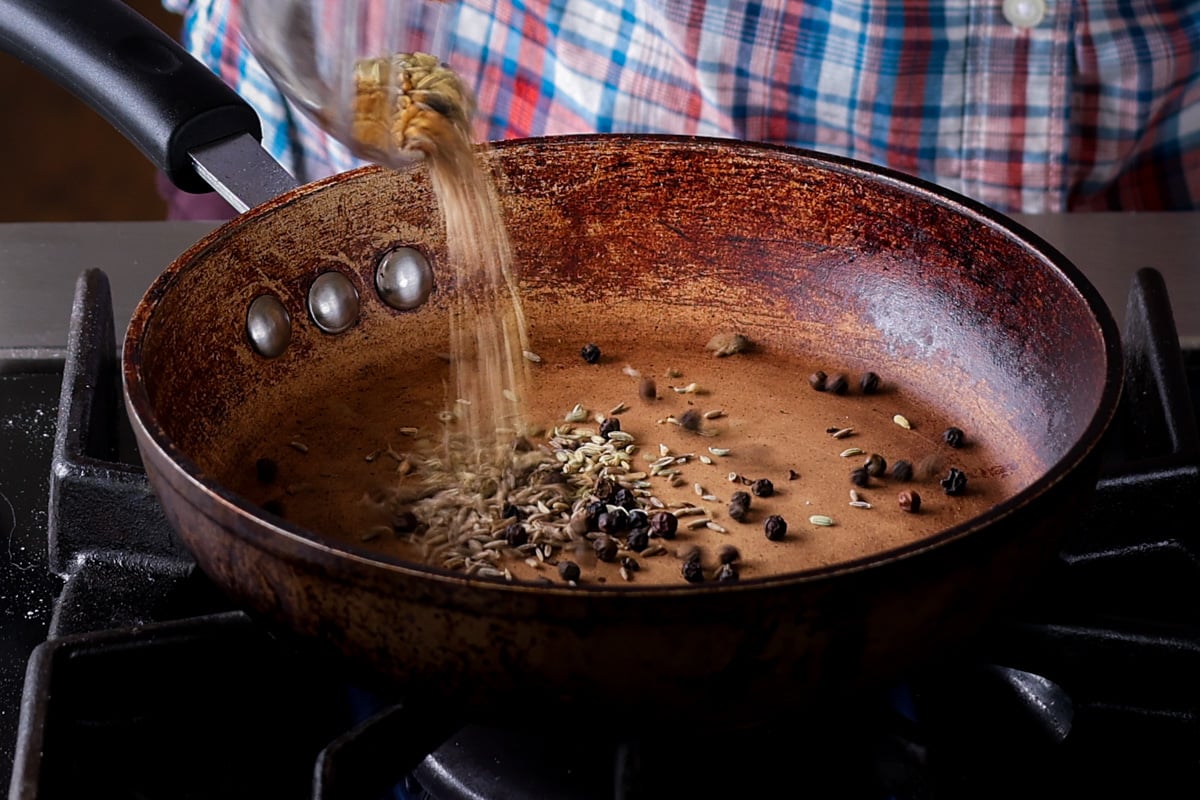 adding whole spices to the pan