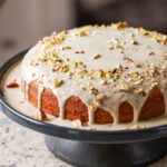 triple pistachio cake on a cake stand