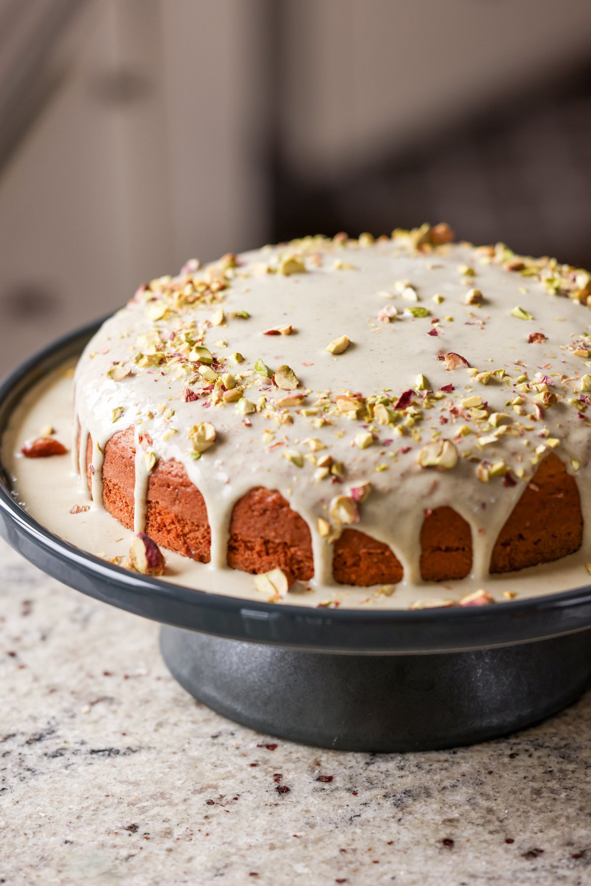 triple pistachio cake on a cake stand