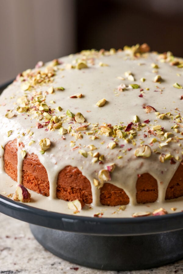 triple pistachio cake on a cake stand