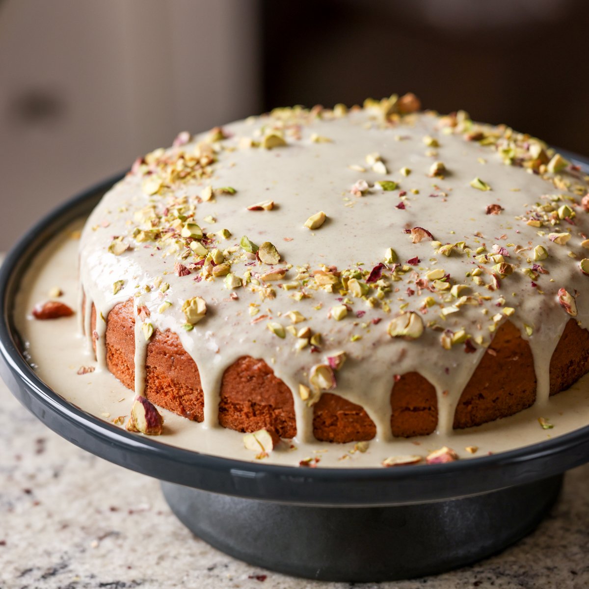 triple pistachio cake on a cake stand