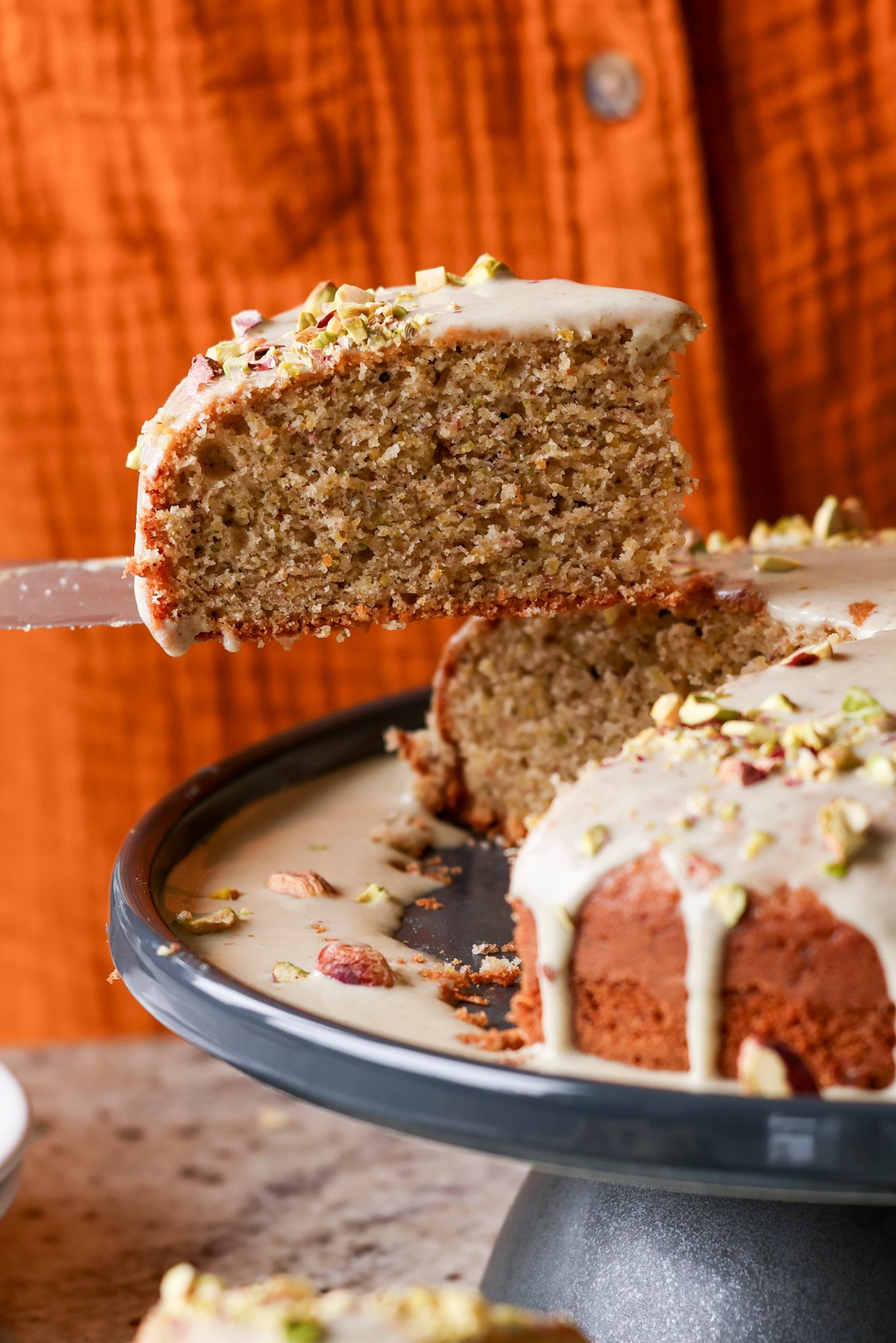 serving a slice of pistachio cake