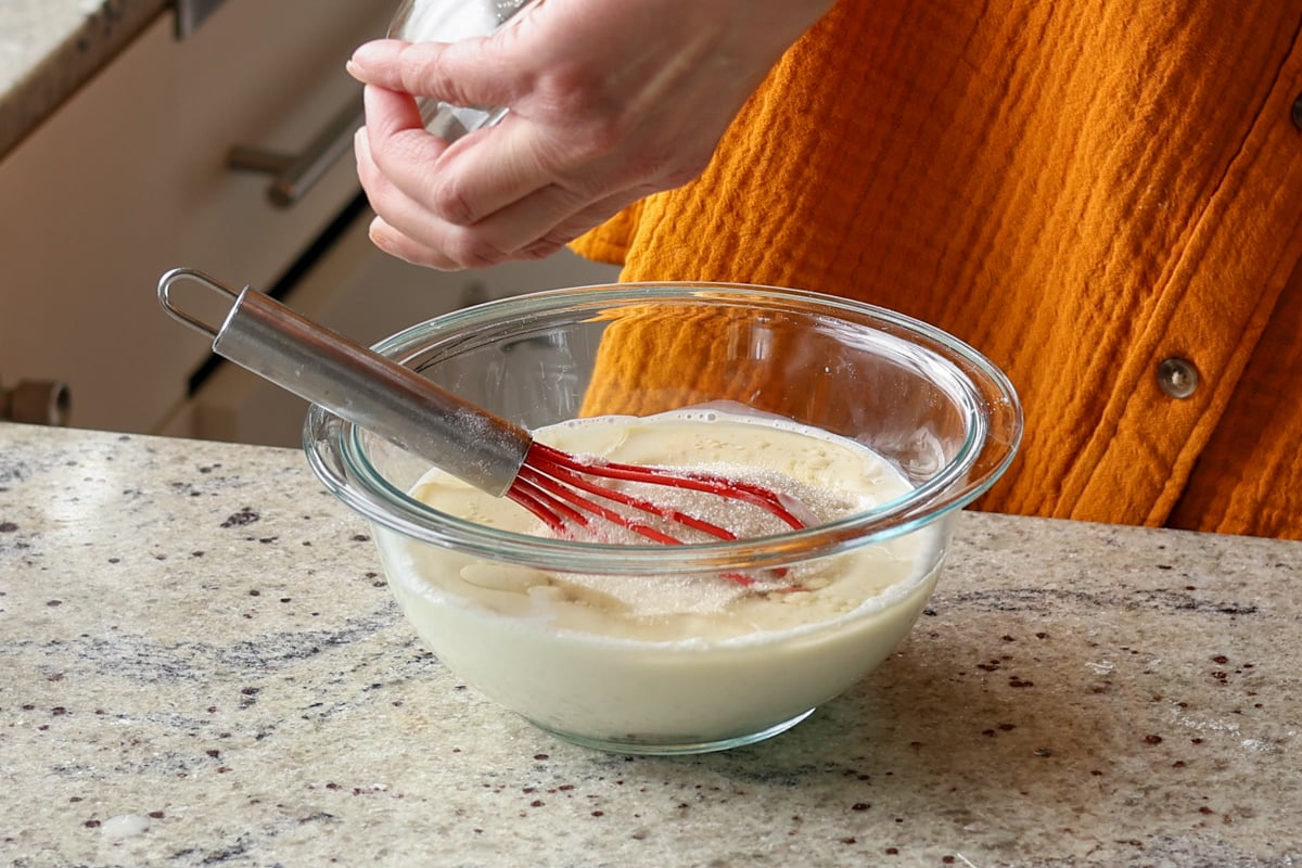 adding non-dairy milk, sugar, and vinegar to the bowl
