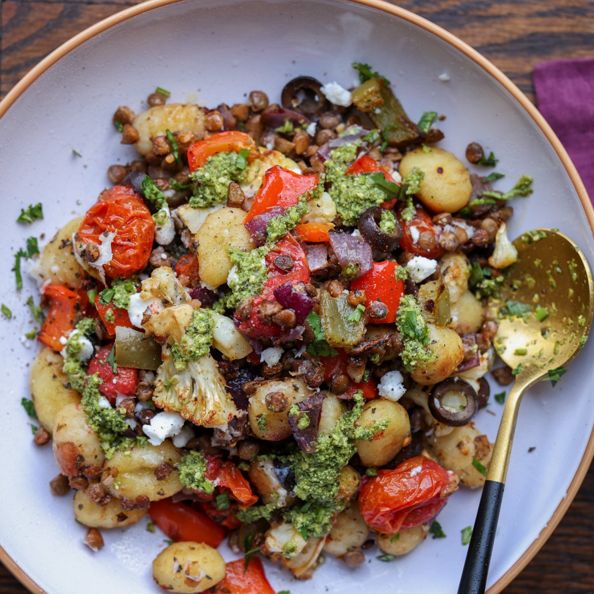 sheet pan gnocchi in a bowl with a spoon