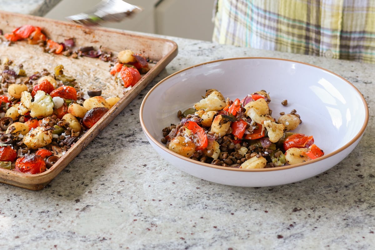 serving a bowl of sheet pan gnocchi