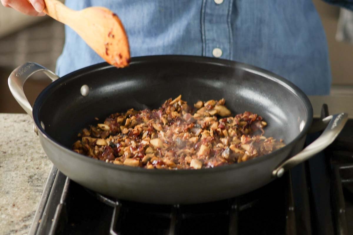 cooked mushrooms and aromatics in the pan