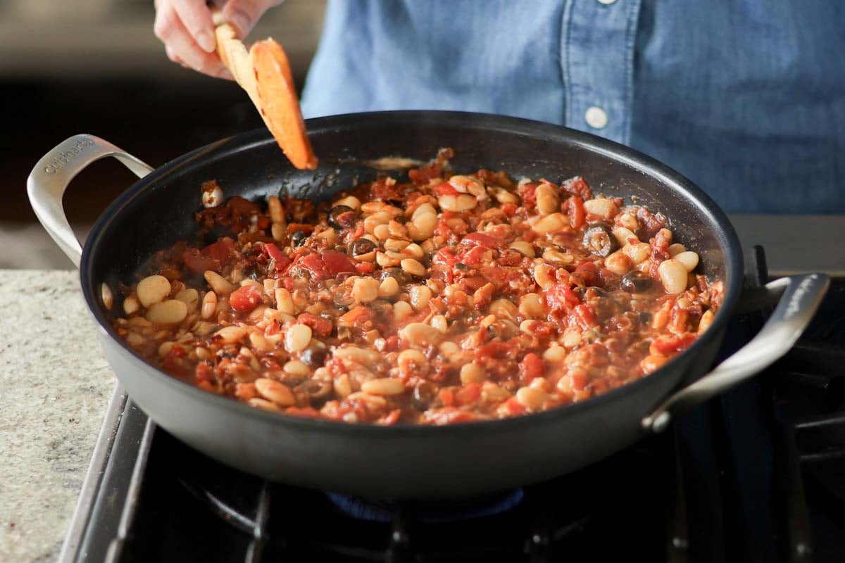 puttanesca beans in the pan before simmering