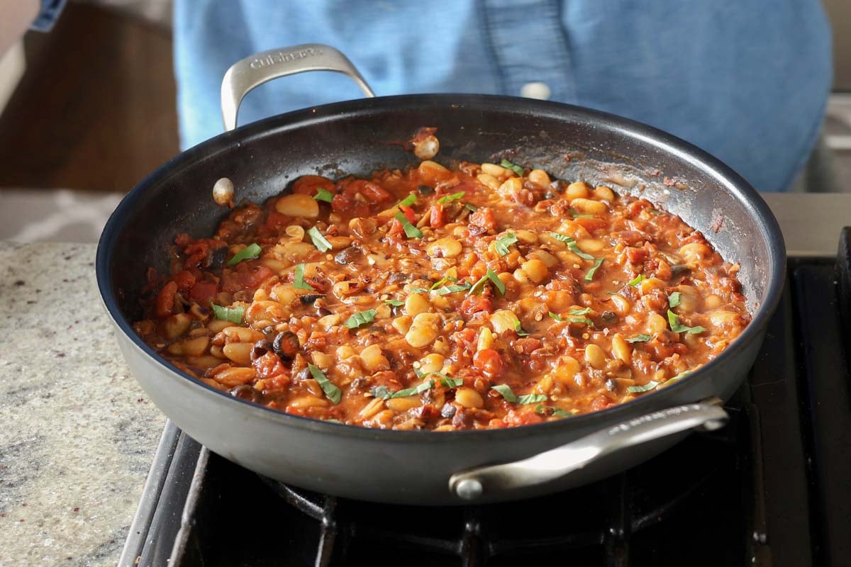 puttanesca beans in the pan after simmering