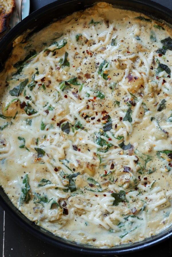 spinach artichoke gnocchi in the pan