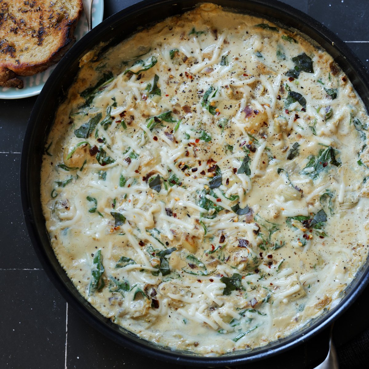 spinach artichoke gnocchi in the pan