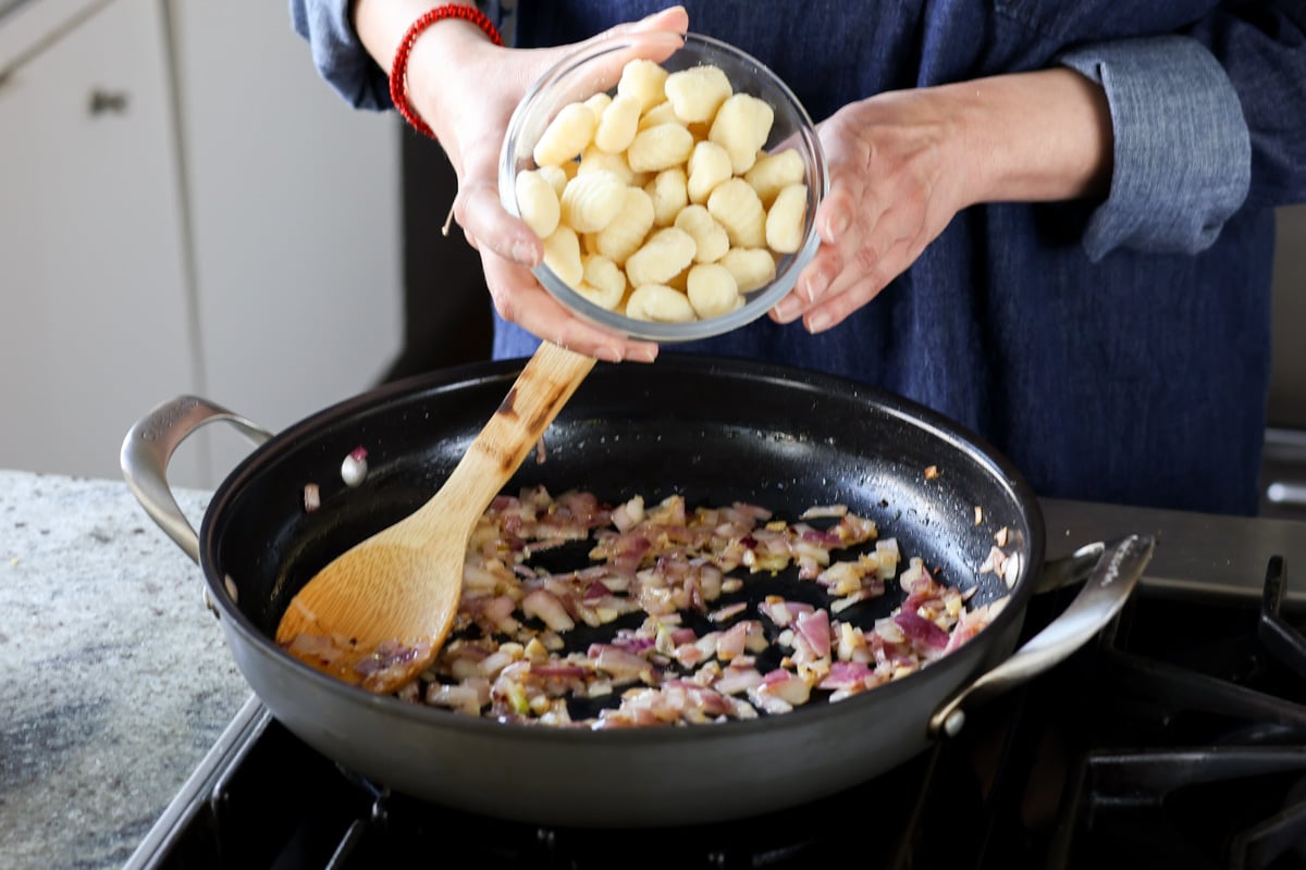 adding gnocchi to the pan