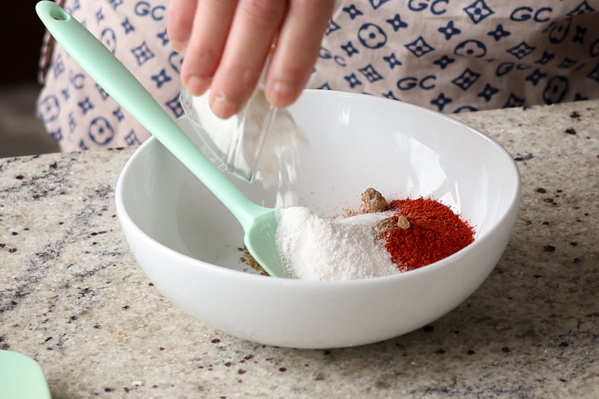 adding cornstarch and spices to the mixing bowl