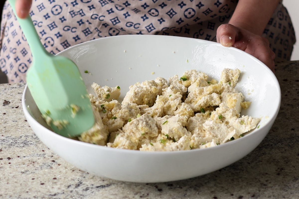 tossing the tofu in the aromatics