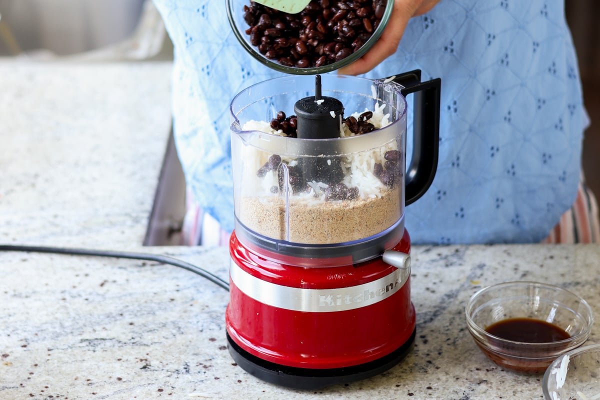 Black beans being added to the food processor.