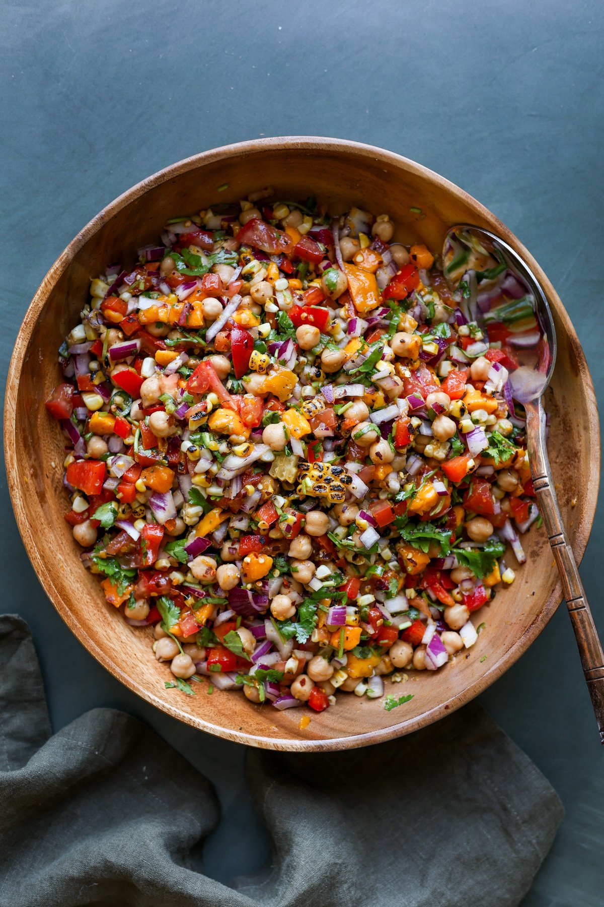 mango chickpea salad in a serving bowl with a spoon