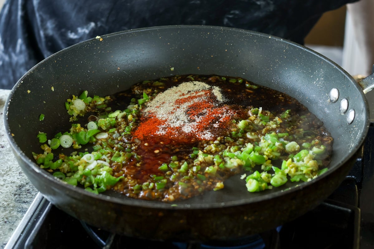 spices and sauces added to the pan of aromatics