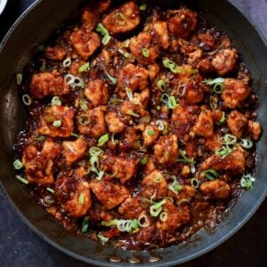 Indo-Chinese garlic pepper tofu in the pan with green onion