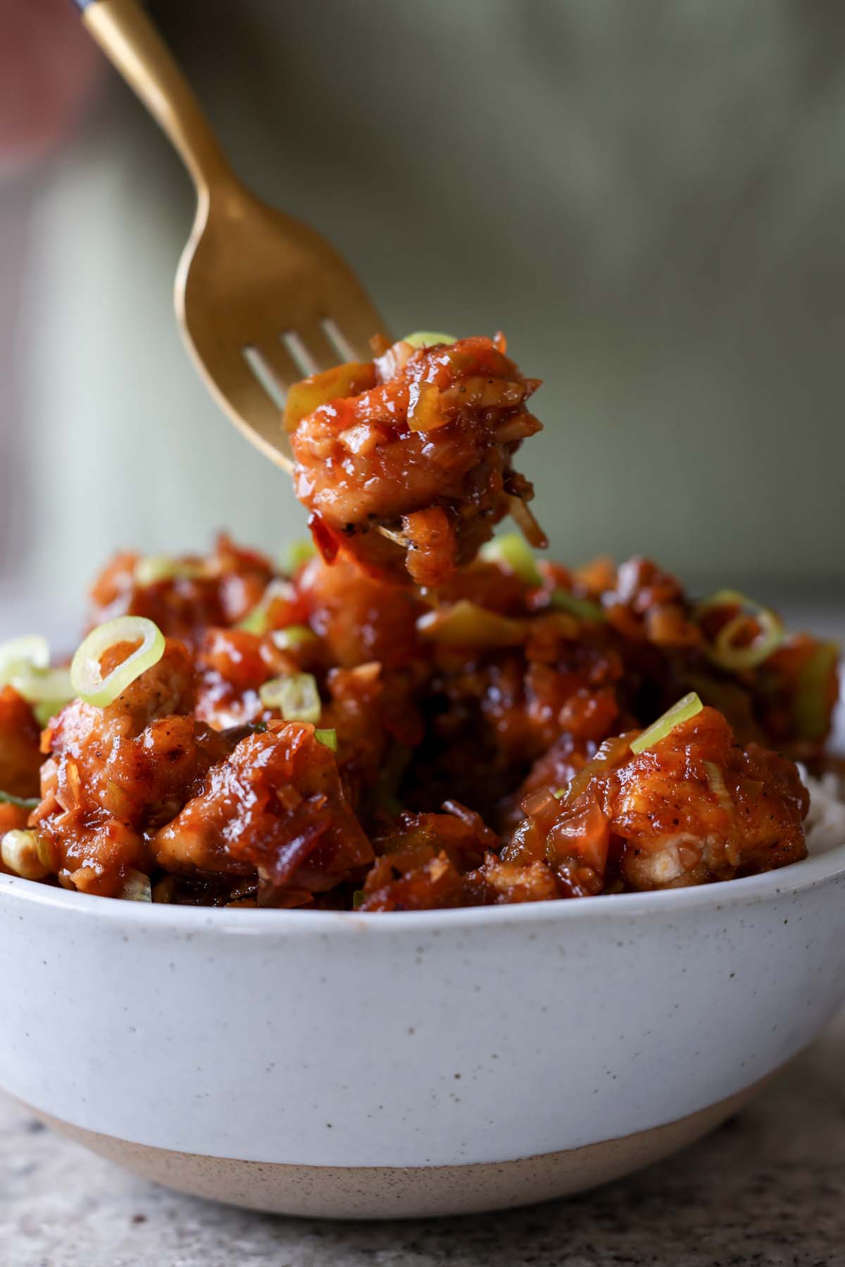 fork taking a bite of Indo-Chinese garlic pepper tofu