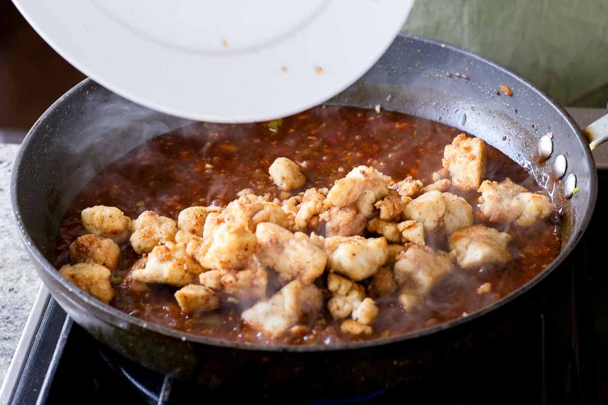 adding tofu to the thickened Indo-Chinese garlic pepper sauce