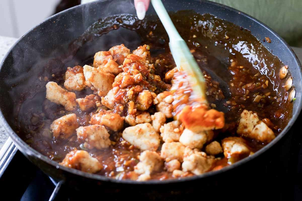mixing tofu into the sauce