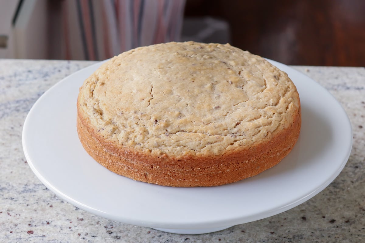 Italian cream cake on a cake stand after baking