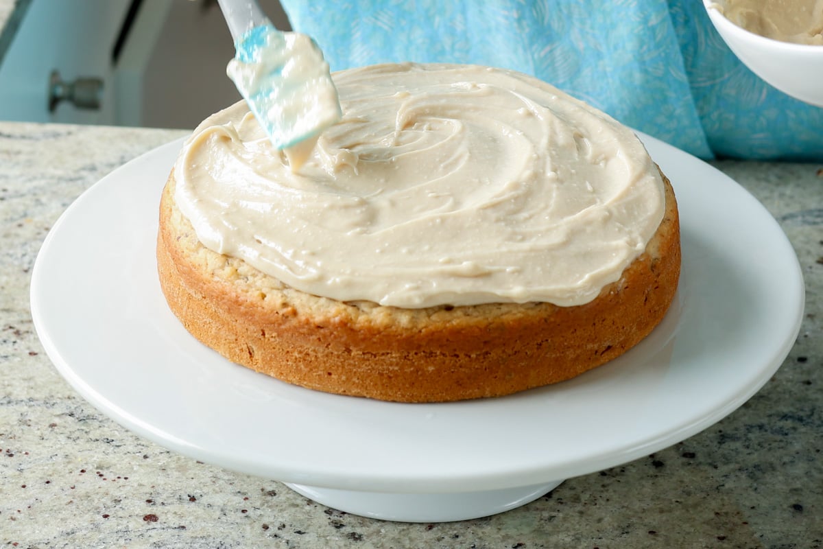 spreading out the frosting on the Italian cream cake